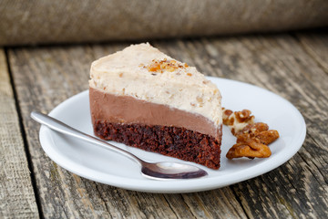 Tasty nuts cake on wooden background.