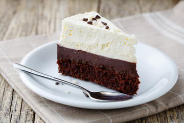 Vanilla cheesecake slice on wooden background.