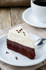 Vanilla cheesecake slice on wooden background.