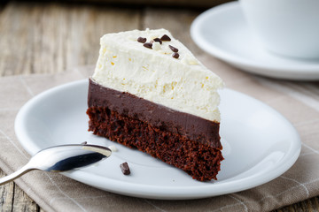 Vanilla cheesecake slice on wooden background.