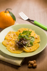 orange carpaccio salad with hazelnut, selective focus