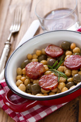 chick pea with fried smoked sausages on dish