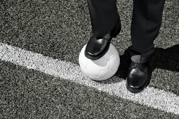Manager with Soccer Ball on the Touchline