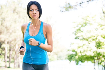 Sporty young woman running outdoors