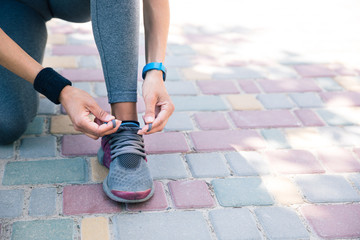 Female hands tying shoelaces