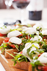 Tomato, mozzarella and arugula sandwich