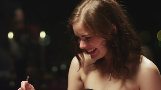 Cute girl laughing at her date during dinner