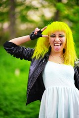 Beautiful hipster young woman with yellow hair in park
