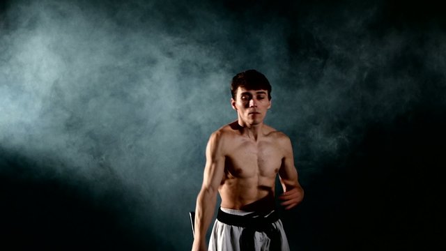 man  practicing karate or kung fu. Master holding nunchuck