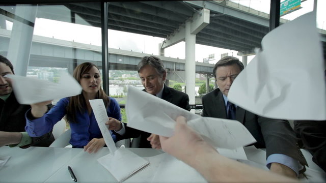 A first person view of Business Professionals passing papers around