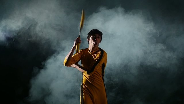 man  practicing kung fu or karate. Master holding nunchuck. Slow