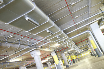 Underground park of a mall with columns and ventilation ducts