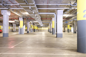Underground park of a mall with columns and ventilation ducts