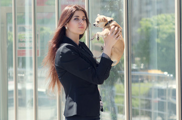 woman holding a dog on the street