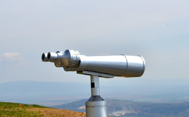 big silver metal binoculars to see the landscape