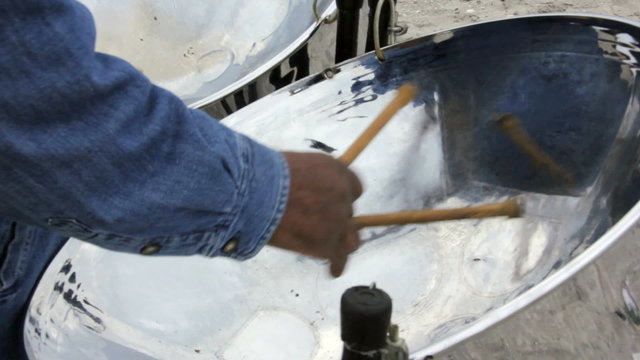 Close up of a man playing the steel drums.