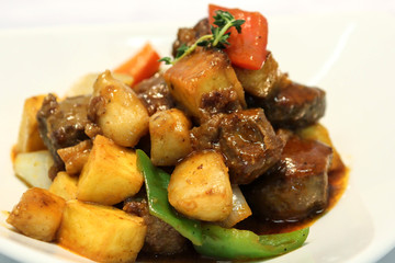 Delicious liver with some potatoes and peppers.