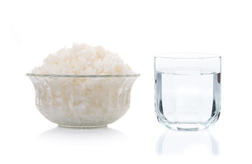 cooked rice and glass of water isolate one white background