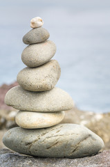 Fototapeta na wymiar Pile of Smooth Stones on a Beach. Concept of Balance and Harmony