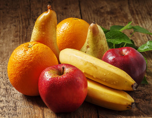 Colored fruits: apple, banana, orange, pear, selective focus