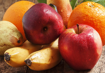 Colored fruits: apple, banana, orange, pear, selective focus