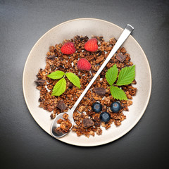 Granola with chocolate and fresh berries. Healthy breakfast.