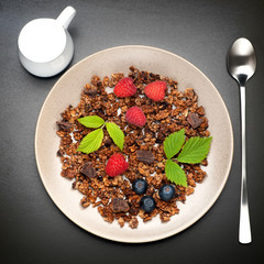 Chocolate Granola with raspberries and blueberries. top view