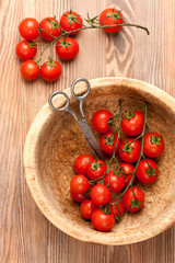 Cherry tomatoes in rustic bowl. top view