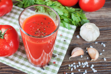 tomato juice and fresh tomatoes on wooden table