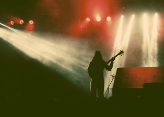 Guitarist silhouette in smoke during concert - retro style photo