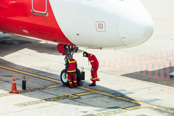 Airplane in airport serviced by the ground crew before departure