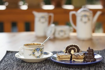 dessert with coffee, chocolate cakes and rolls