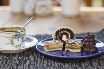 dessert with coffee, chocolate cakes and rolls