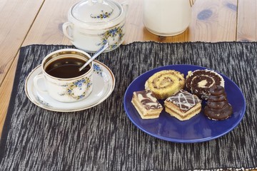 dessert with coffee, chocolate cakes and rolls