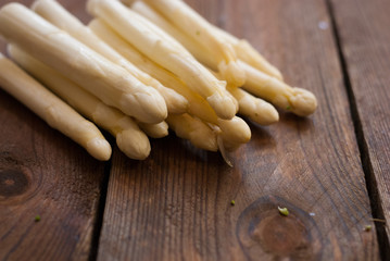 white asparagus tips on raw wooden table