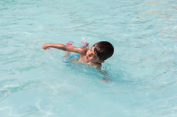 European boy swimming in the pool