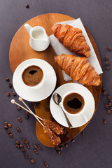 Fresh croissants  and cup of coffee on a table