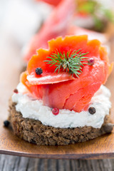 Sandwich with salted red salmon close up.