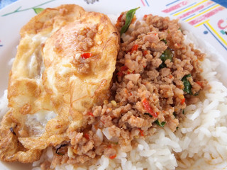 Close up Rice topped with stir fried pork and basil
