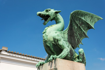 Green dragon on the dragon bridge in Ljubljana on a sunny day