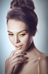 Fototapeta premium Beautiful fashion girl with delicious orange praline 