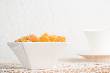 Candy ginger in white porcelain bowl
