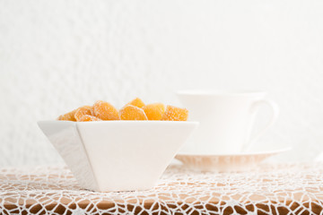 Candy ginger in white porcelain bowl