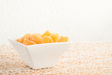 Candy ginger in white porcelain bowl