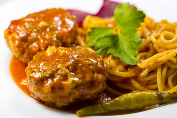 Meatballs with spaghetti on a white plate