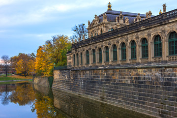 Fototapeta na wymiar Colorful autumn view of Zwinger from channel. Dresden, Germany.