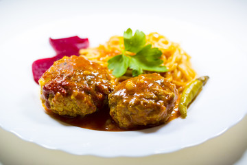 Meatballs with spaghetti on a white plate