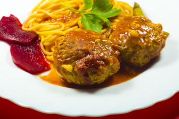 Meatballs with spaghetti on a white plate