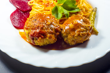 Meatballs with spaghetti on a white plate