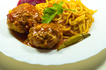 Meatballs with spaghetti on a white plate